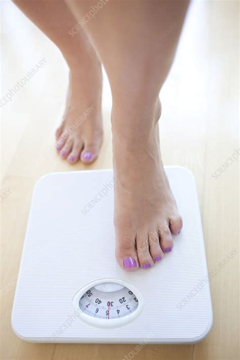 woman weighing herself stock image f003 4578 science photo library
