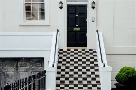 Checkered Black And White Residential Outdoor Stairway And Black Door