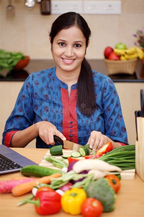 Young Indian Woman Cutting Vegetables Stock Photo Image Of Hispanic