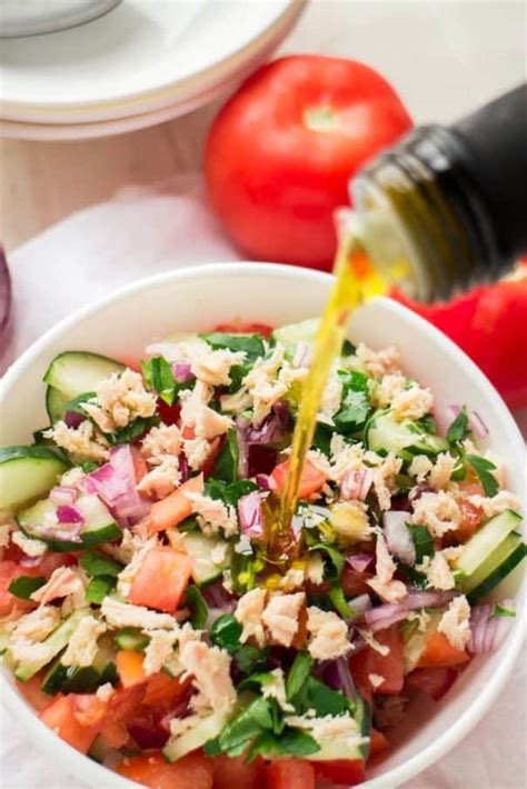 Flake the tuna over the salad, dress with sherry vinegar, the oil from the tuna, flaky salt and pepper and serve. Tuna Cucumber Tomato Salad With Olive Oil Dressing