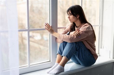 Sad Woman Looking Out Of Window At Home Stock Photo By Prostock Studio