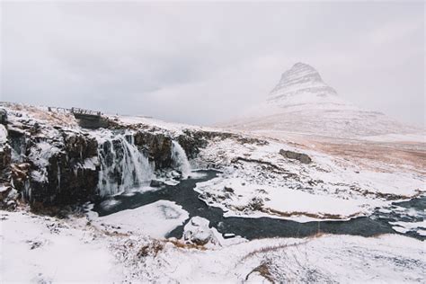 Beautiful Kirkjufellfoss By The Kirkjufell Mountain In Winter Iceland