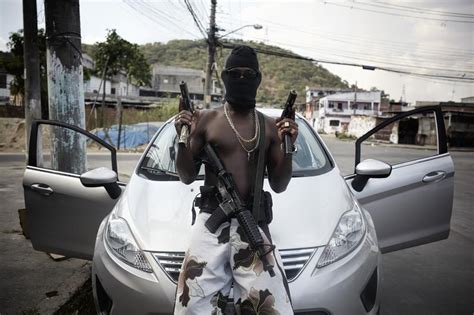A Gang Member Also Known As A Trafficante Poses With His Weapons In