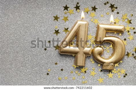 Number 45 Gold Celebration Candle On Star And Glitter Background