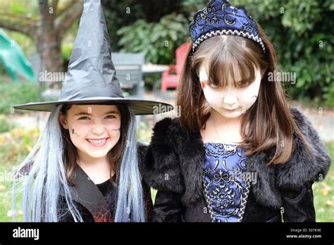 Two Spooky Little Girls Acting The Part For Halloween Stock Photo Alamy