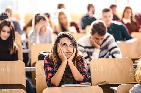 Female College Student Feeling Bored On A Class At Lecture Hall Stock