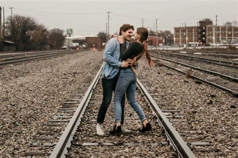 Woman And Man Standing On Train Track During Daytime Photo Free Rail Image On Unsplash Train
