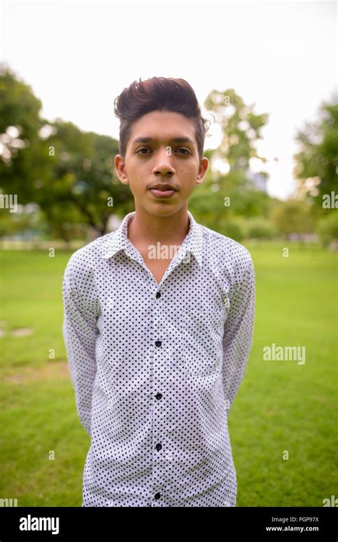 Portrait Of Young Indian Teenage Boy Relaxing At The Park Stock Photo