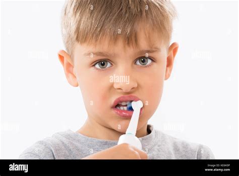 Close Up Of Boy Brushing Teeth With Electric Toothbrush Stock Photo Alamy