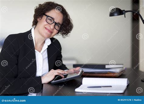 Spanish Businesswoman Smiling At The Camera At The Office Stock Photo