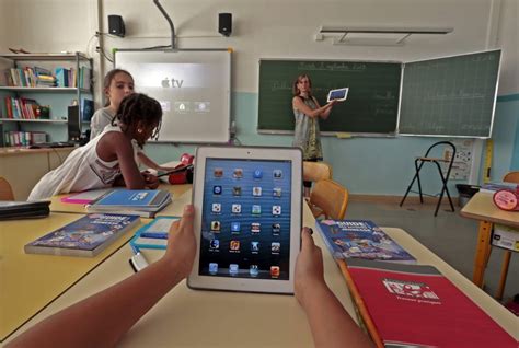 Elementary School Children Use Electronic Tablets On The First Day Of