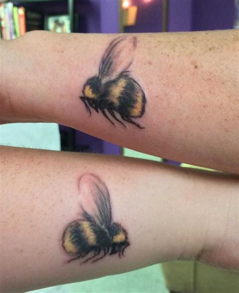 Two Tattoos On The Arms Of People That Have Bees On Them Both With