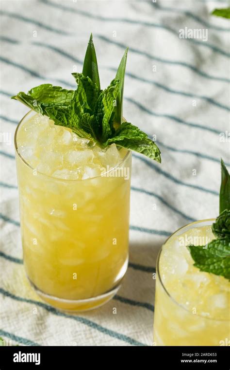 Homemade Boozy Green Chartreuese Swizzle Cocktail With Mint Stock Photo