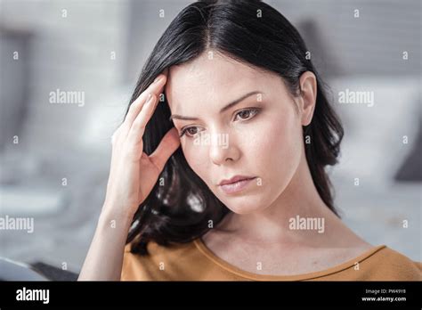 Serious Woman Touching Her Forehead Stock Photo Alamy
