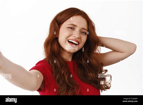 Close Up Portrait Of Ginger Girl Taking Selfie On Smartphone Posing At Camera Laughing And