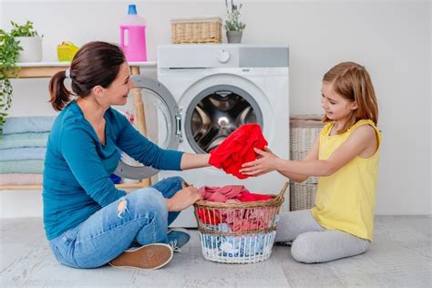 Premium Photo Mother With Daughter Sitting On Floor Near Washing