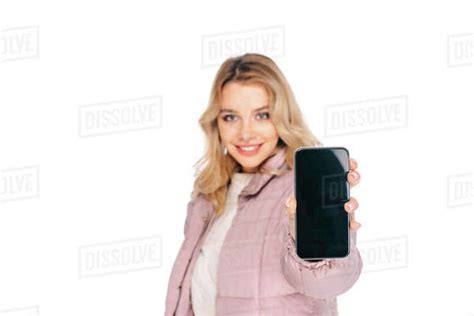 Young Woman Holding Smartphone With Blank Screen And Smiling At Camera Isolated On White Stock