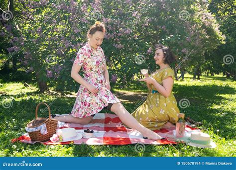 Two Pretty Pin Up Ladies Having Nice Picnic In The City Park In A Sunny