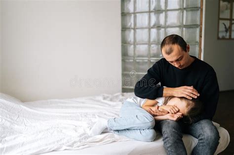 Portrait Of Loving Caring Father Comforting Offended Sad Little