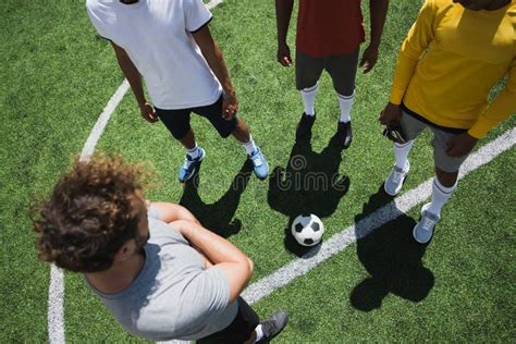 Group Of Soccer Players During Soccer Match On Pitch Stock Photo