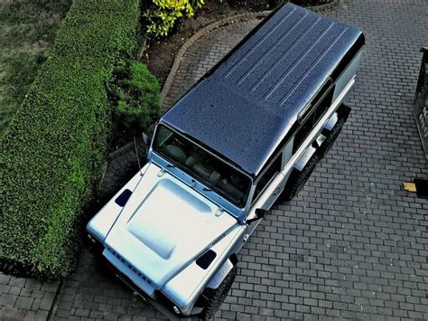 A White Truck Parked On Top Of A Brick Road
