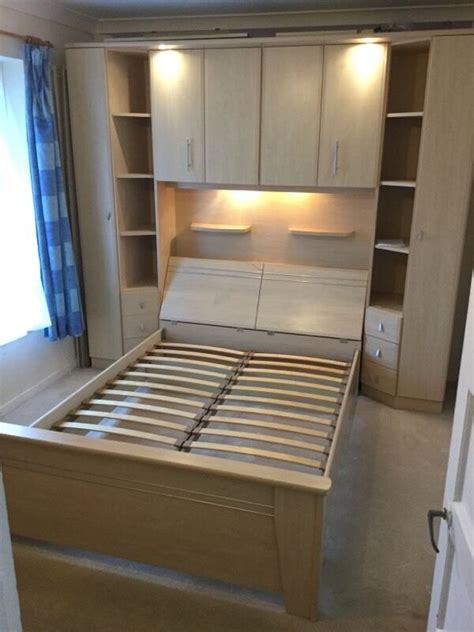 The storage space under the bed holds everything from extra comforters and pillows to seasonal clothes. IKEA over bed storage & end cupboards with double bed ...