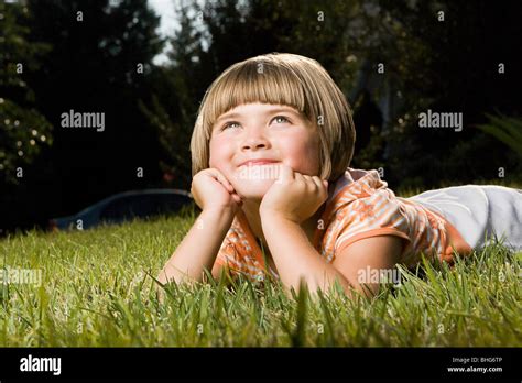 Girl Lying On Grass Stock Photo Alamy
