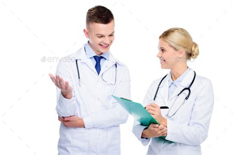 Male And Female Doctors In White Coats With Stethoscopes And Diagnosis