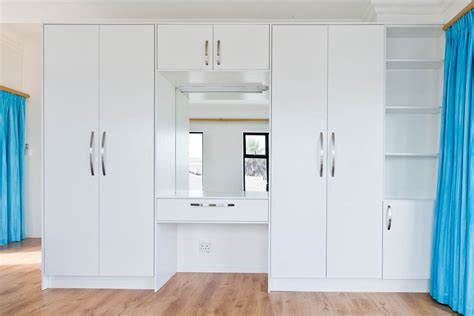 Hull corner cupboard in a modern bedroom. Bedroom Cupboards - Essential Kitchens