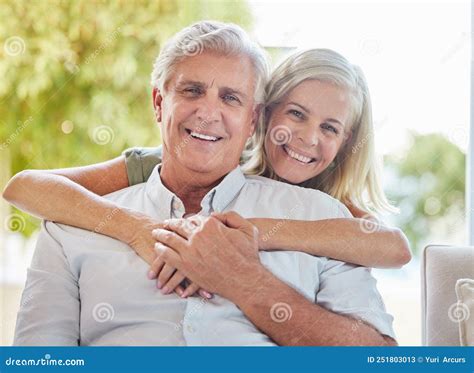 A Happy Mature Caucasian Couple Embracing And Showing Love While Relaxing Together At Home