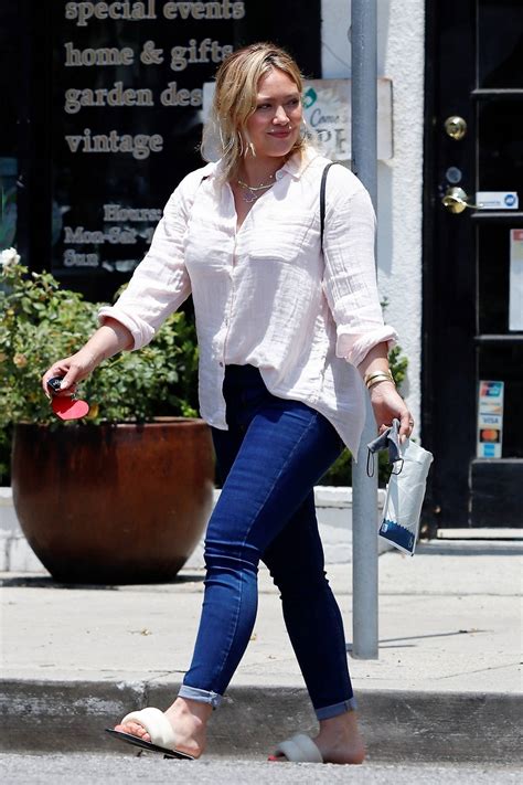 hilary duff wears a light pink shirt and blue skin tight jeans while running a few errands in
