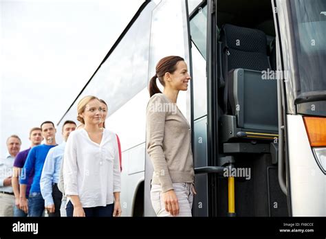 Group Of Happy Passengers Boarding Travel Bus Stock Photo Alamy