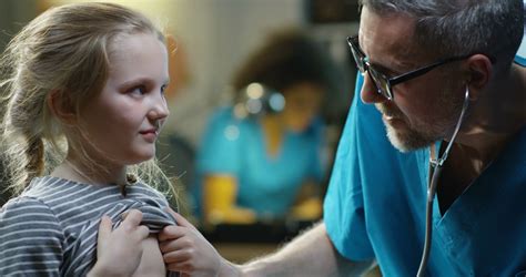 Close Up Of A Male Doctor Examining Girl With Stethoscope Stock Video