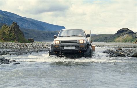 Car Pulling Trailer And Crossing River In Iceland Stock Photo Image