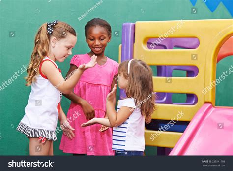 Three Children Playing Clapping Game Together Stock Photo 335541503