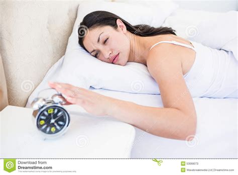 Pretty Brunette Turning Off Alarm Clock On Bed Stock Image Image Of Duvet Long 53068073