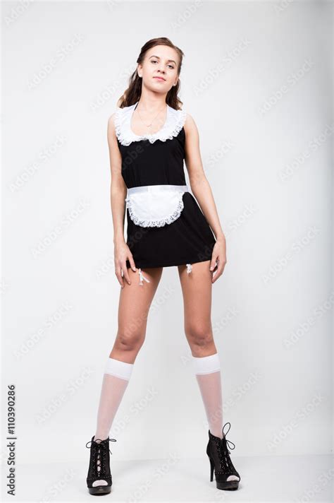 Beautiful Young Woman Dressed As A Sexy Maid Servant In A Skimpy Uniform Posing Provocatively