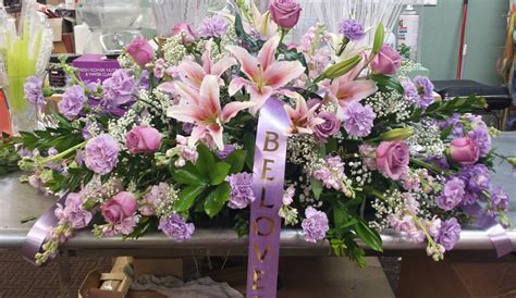 Maybe you would like to learn more about one of these? lavender and purple funeral flowers, lilies carnations ...