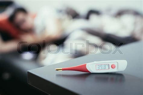 fever thermometer in the foreground stock image colourbox