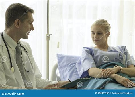 Doctor Doing A Physical Examination Of The Young Beautiful Patient And