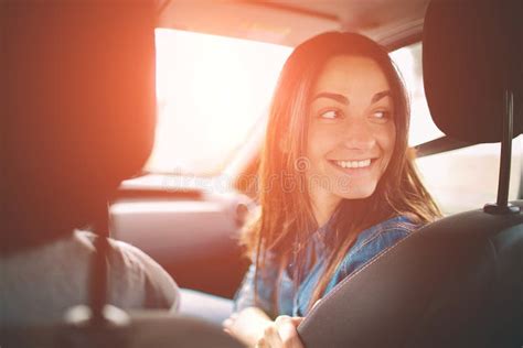 Beautiful Woman Smiling While Sitting On The Front Passenger Seats In The Car Stock Image