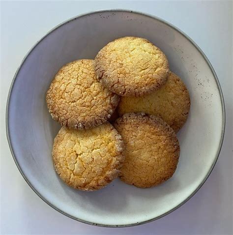 A White Bowl Filled With Cookies On Top Of A Table