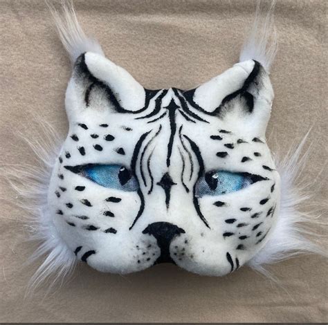 A White And Black Cat Mask With Blue Eyes