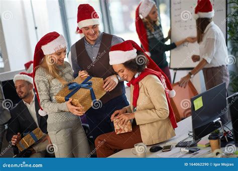 Group Of People In Santa Hat With Christmas Present At Xmas Business