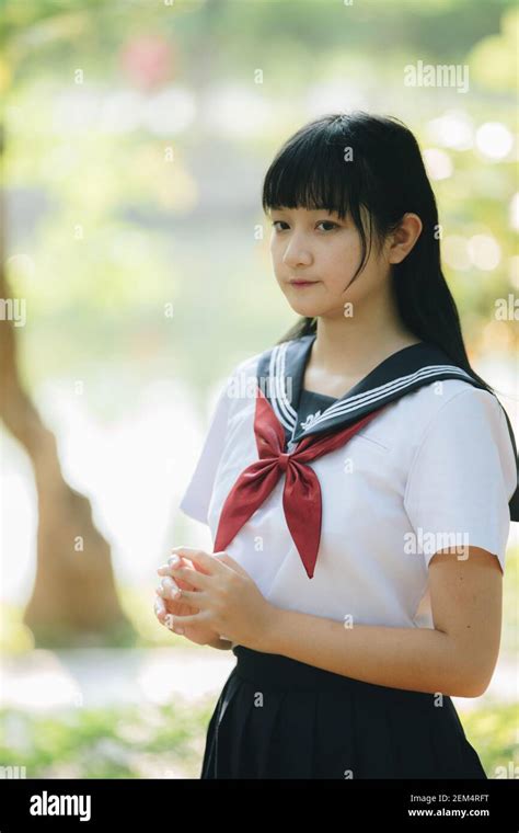 Portrait Of Asian Japanese School Girl Costume Looking At Park Outdoor Film Vintage Style Stock