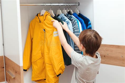 Cute Boy Get Dressed In The Morning For School Kid Organizing Clothes