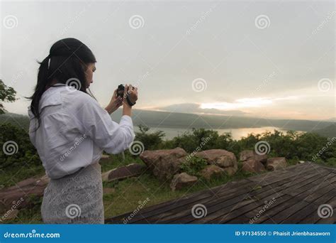Female Photographer Taking Pictures Of The Sunset Stock Photo Image