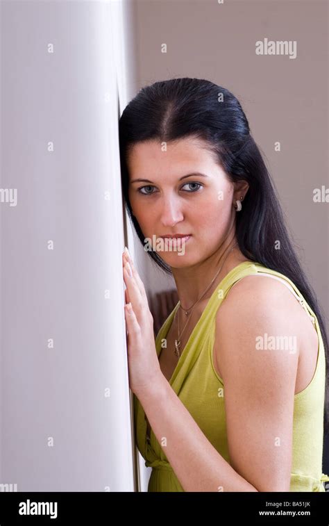 Woman Leaning Against The Wall Stock Photo Alamy