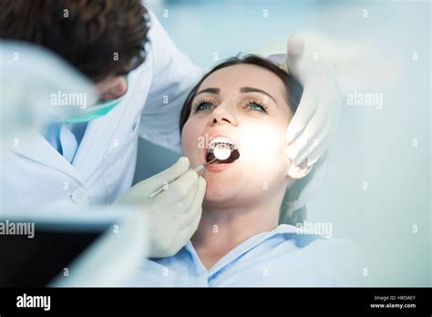 Dentist Examining Patient Teeth With A Mouth Mirror Stock Photo Alamy