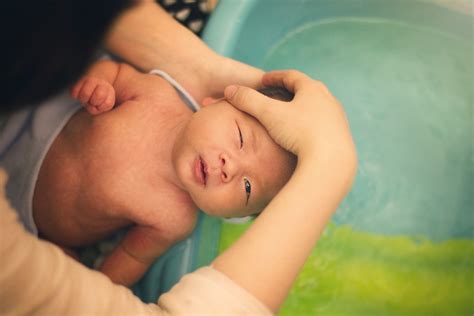 Once you have finished bathing your baby, holding them securely, lift them out and wrap them in a warm, dry towel. How To Treat Your Baby's Dry Skin, According To A Pediatrician